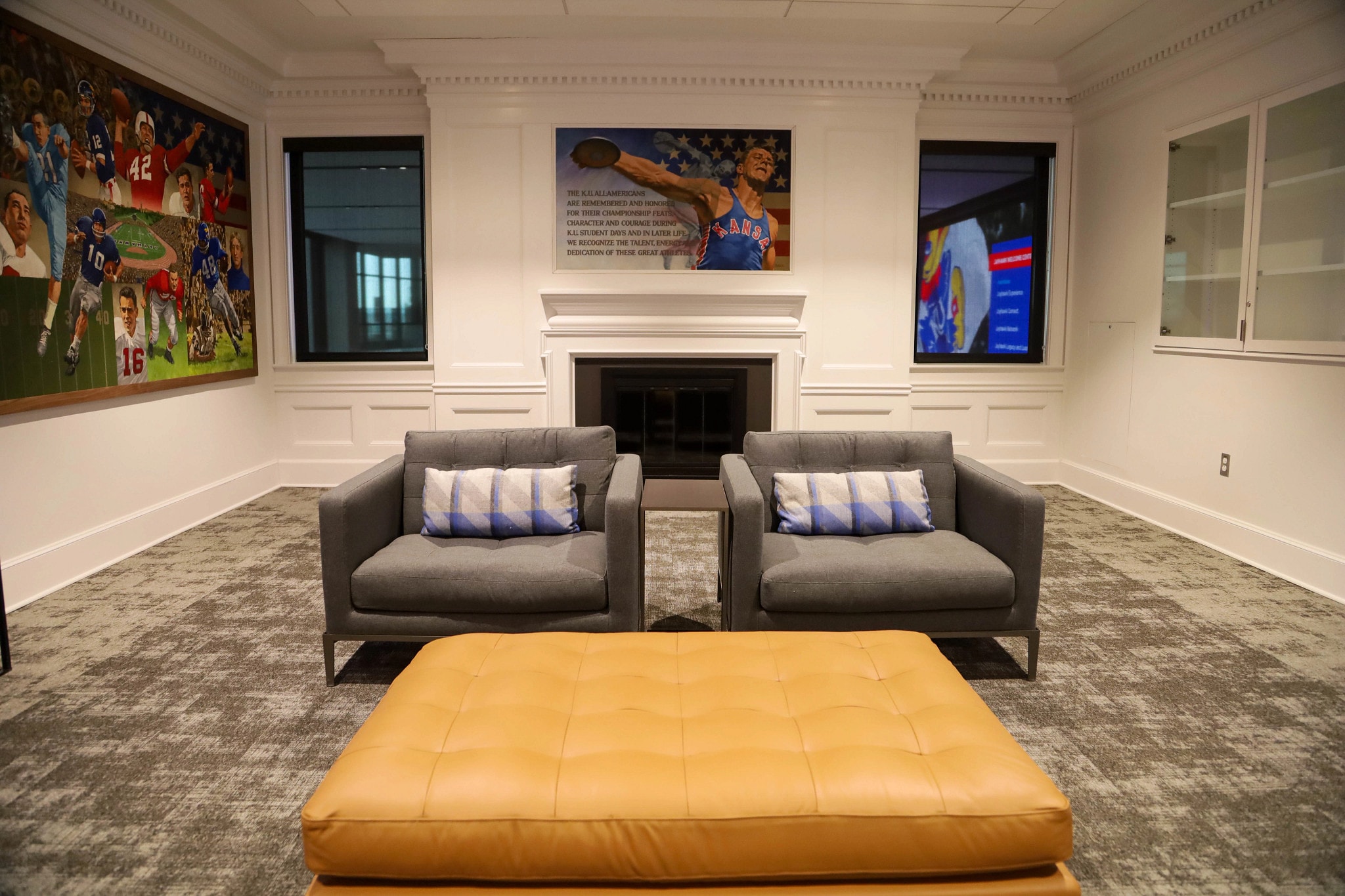 Lounge seating and a fireplace in the All-American Room at the Jayhawk Welcome Center