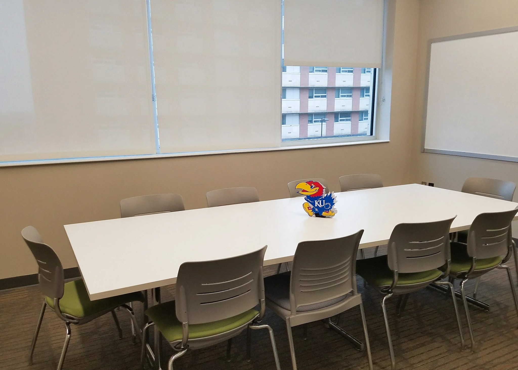 A conference table with office chairs on all sides.