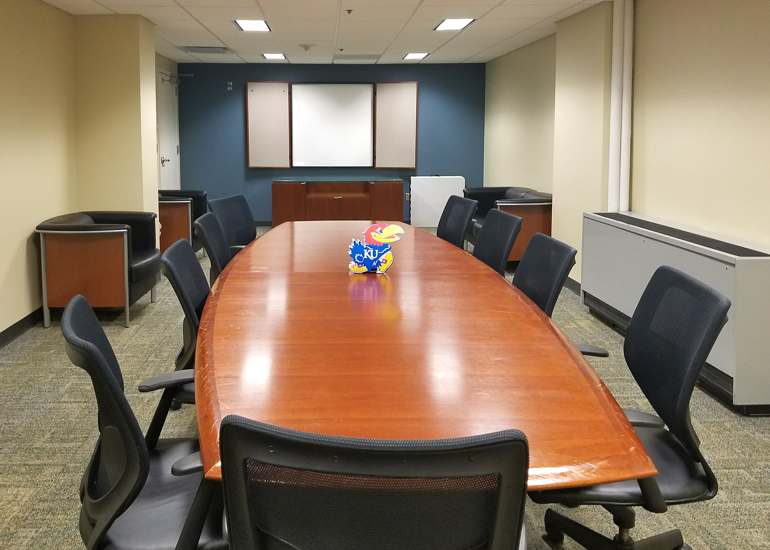 Ellsworth Conference Room with a jayhawk pin on top of the brown table