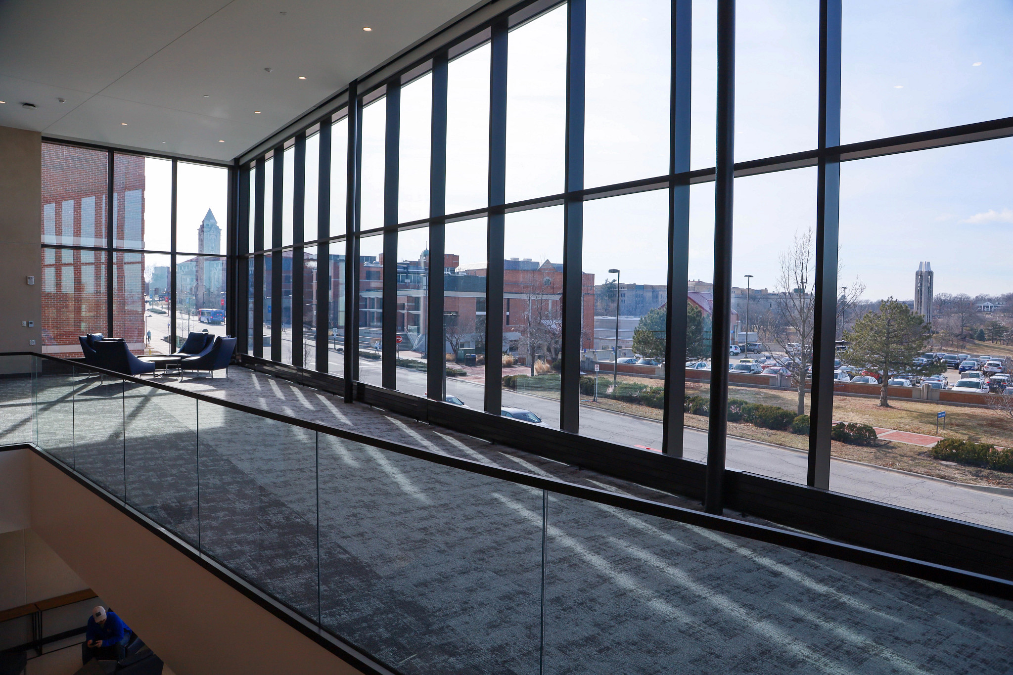 Carpeted, second-floor lobby with view of KU campus, through the window.