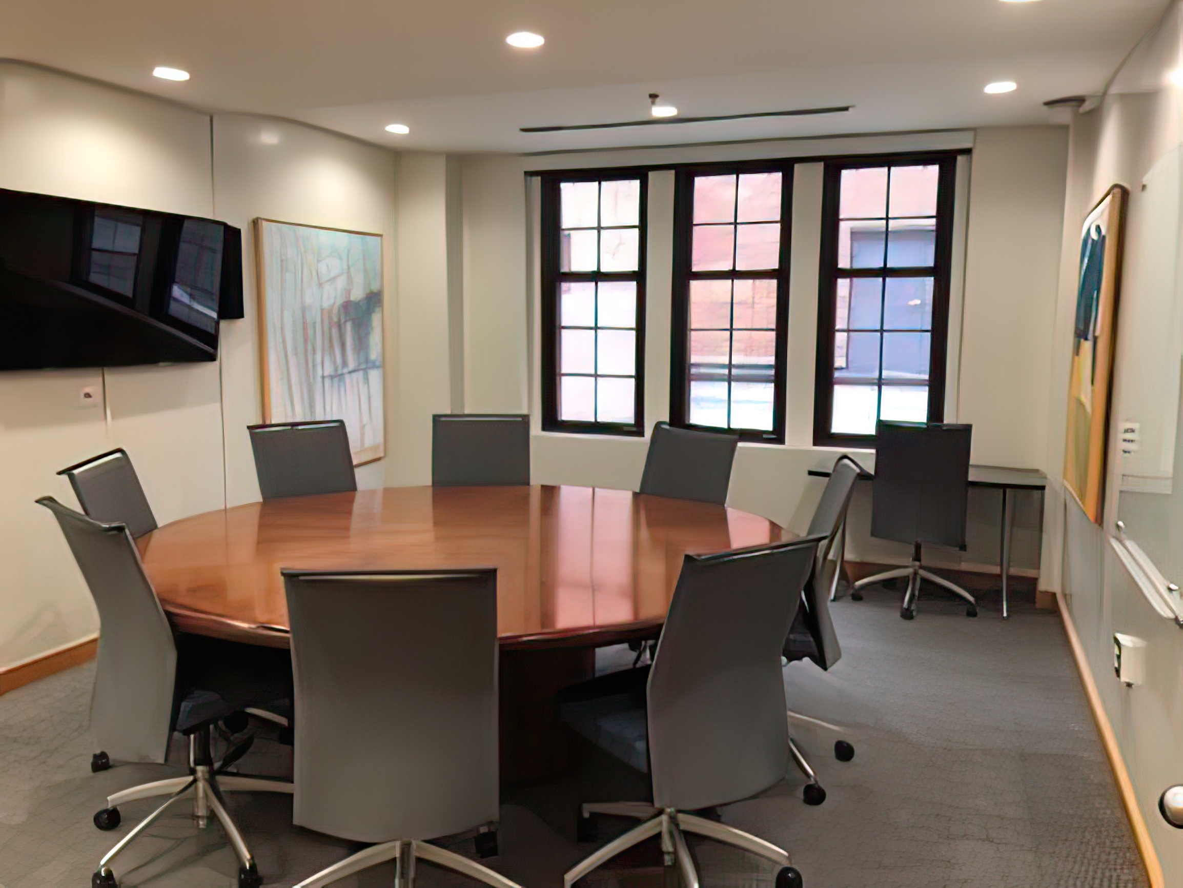 Round conference table lined with chairs.