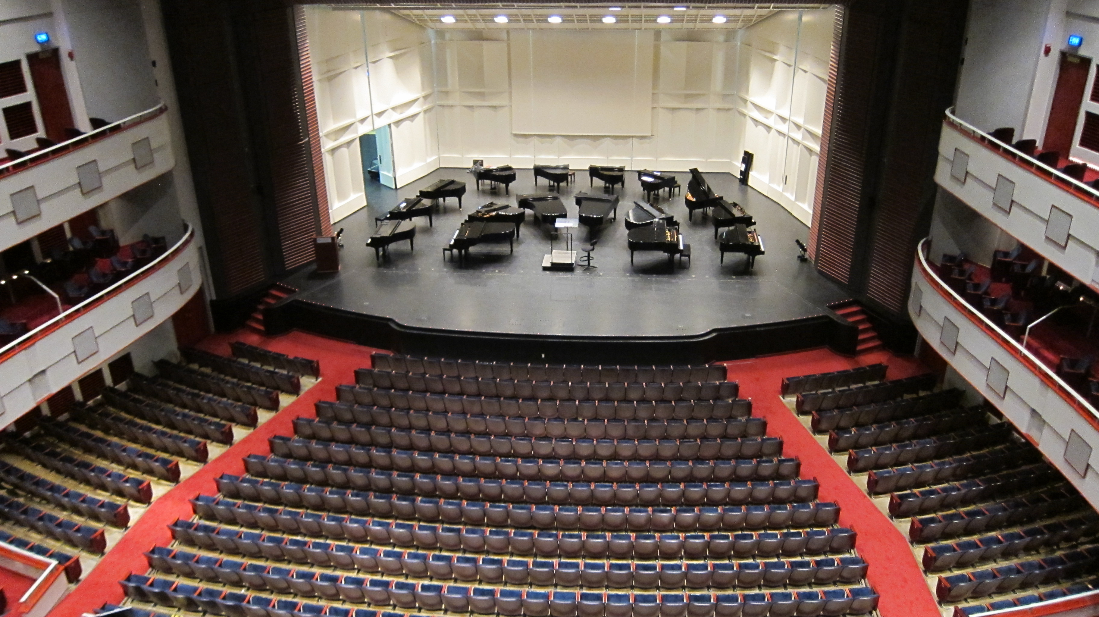 A view of Lied Center auditorium from the balcony looking down at empty seating and the stage.