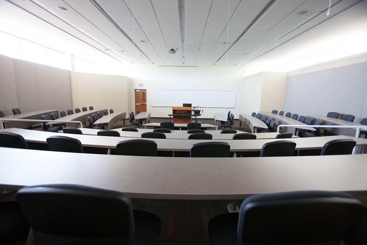 Classroom with long desks and chairs that descend to the center of the room